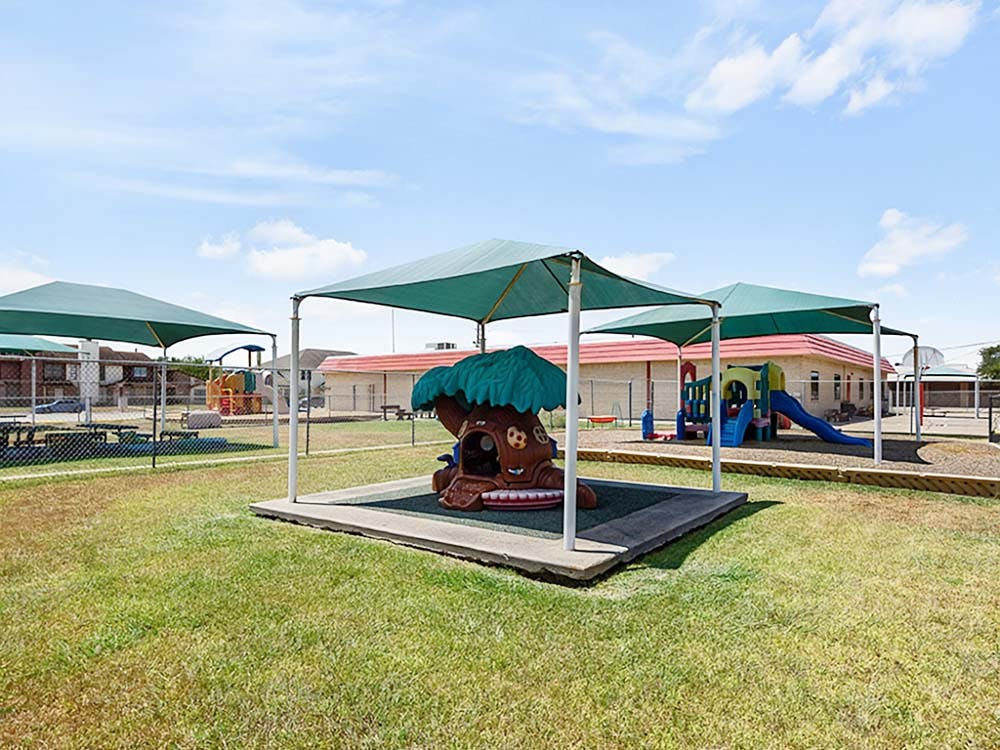 Outdoor children's playground with shade structures and play equipment