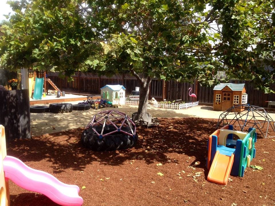 Outdoor playground with slides, playhouses, and climbing domes