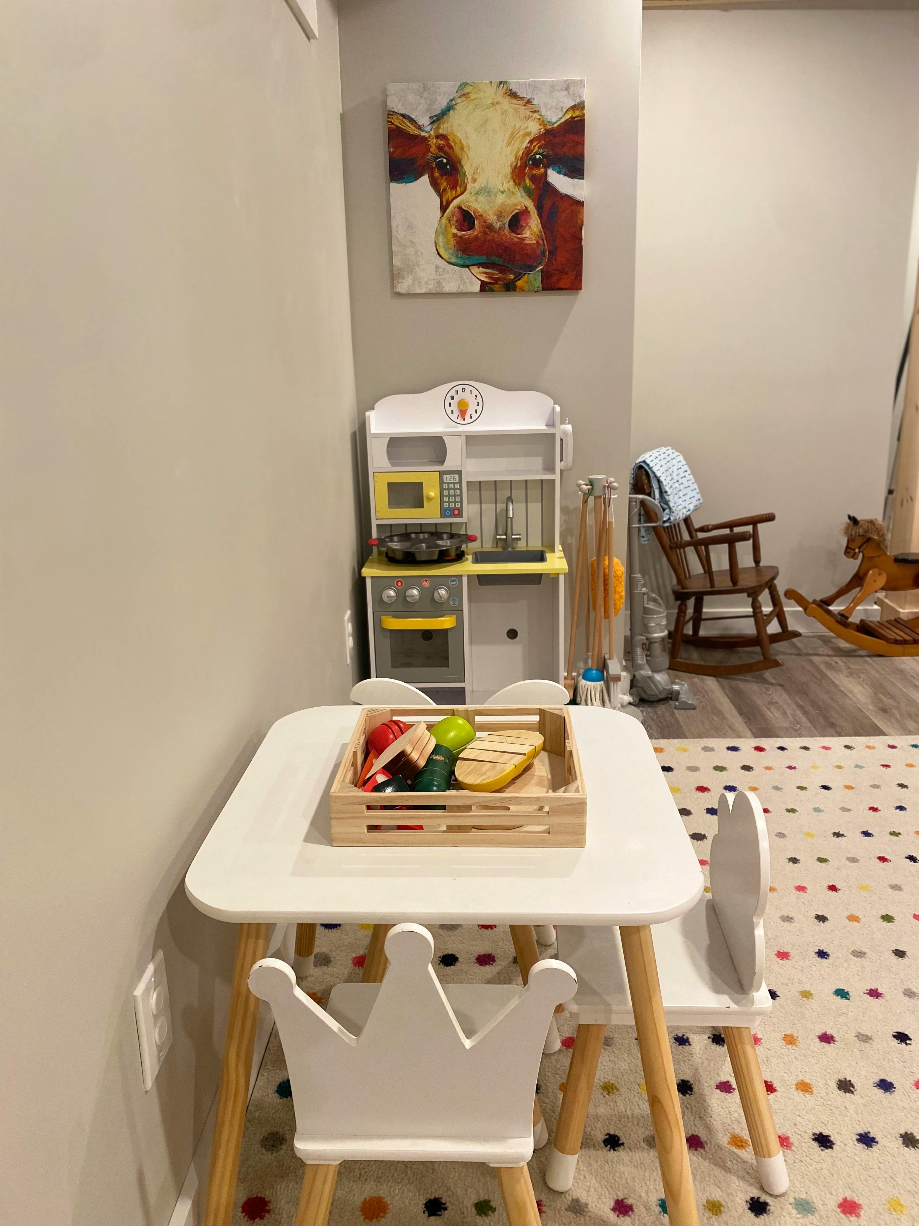 Child's play kitchen and table with toy food