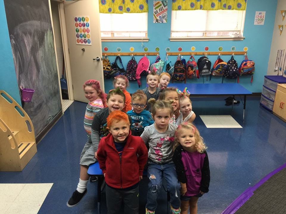 Group of children posing in a classroom