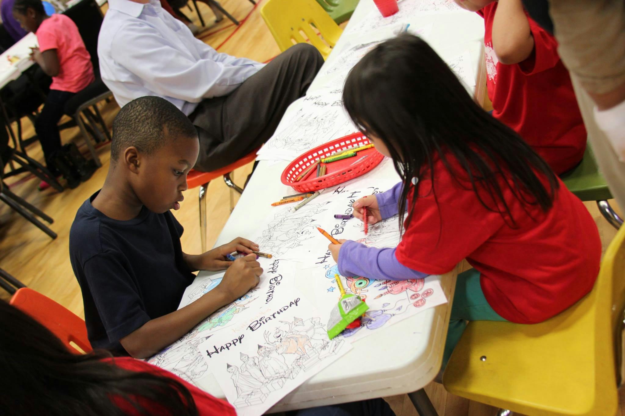 Two children coloring at a table