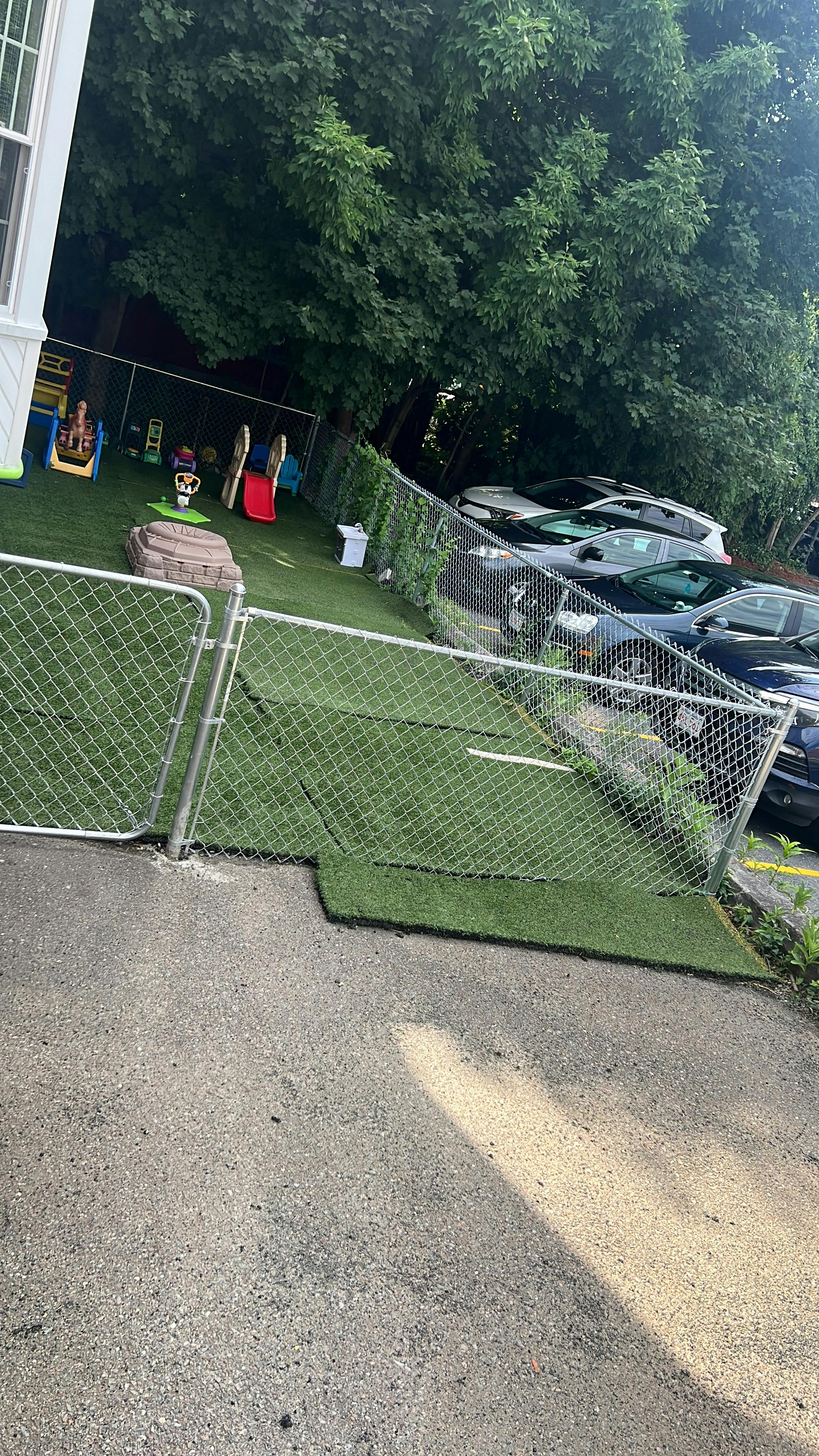 Playground with artificial turf and chain link fence