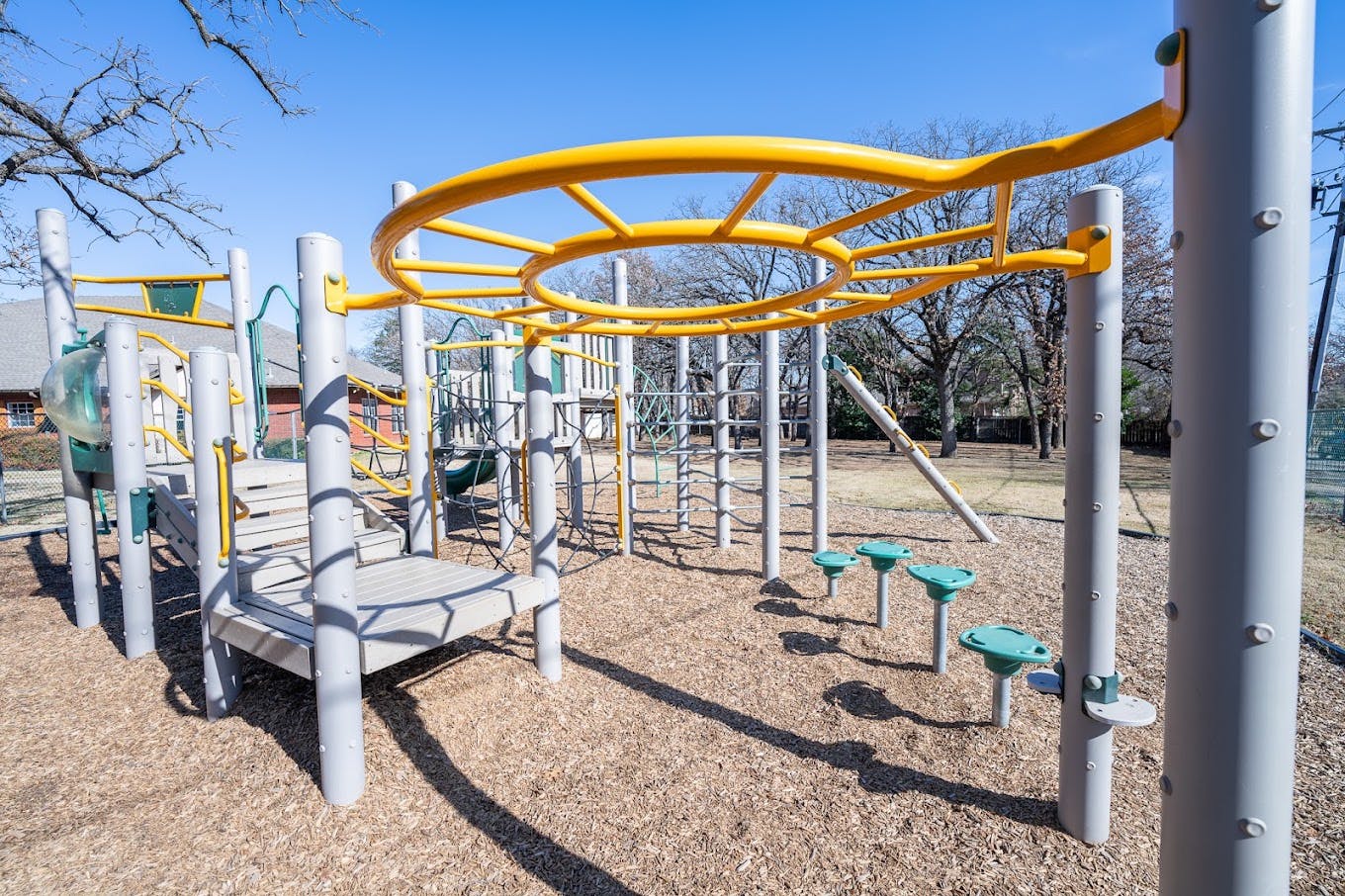 Playground equipment with a circular overhead climbing structure