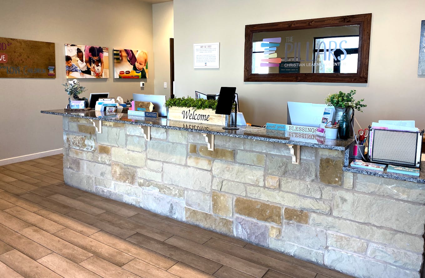 Reception desk with stone base at The Pillars Christian Learning Center