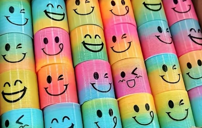Colorful toy springs with various smiley face expressions