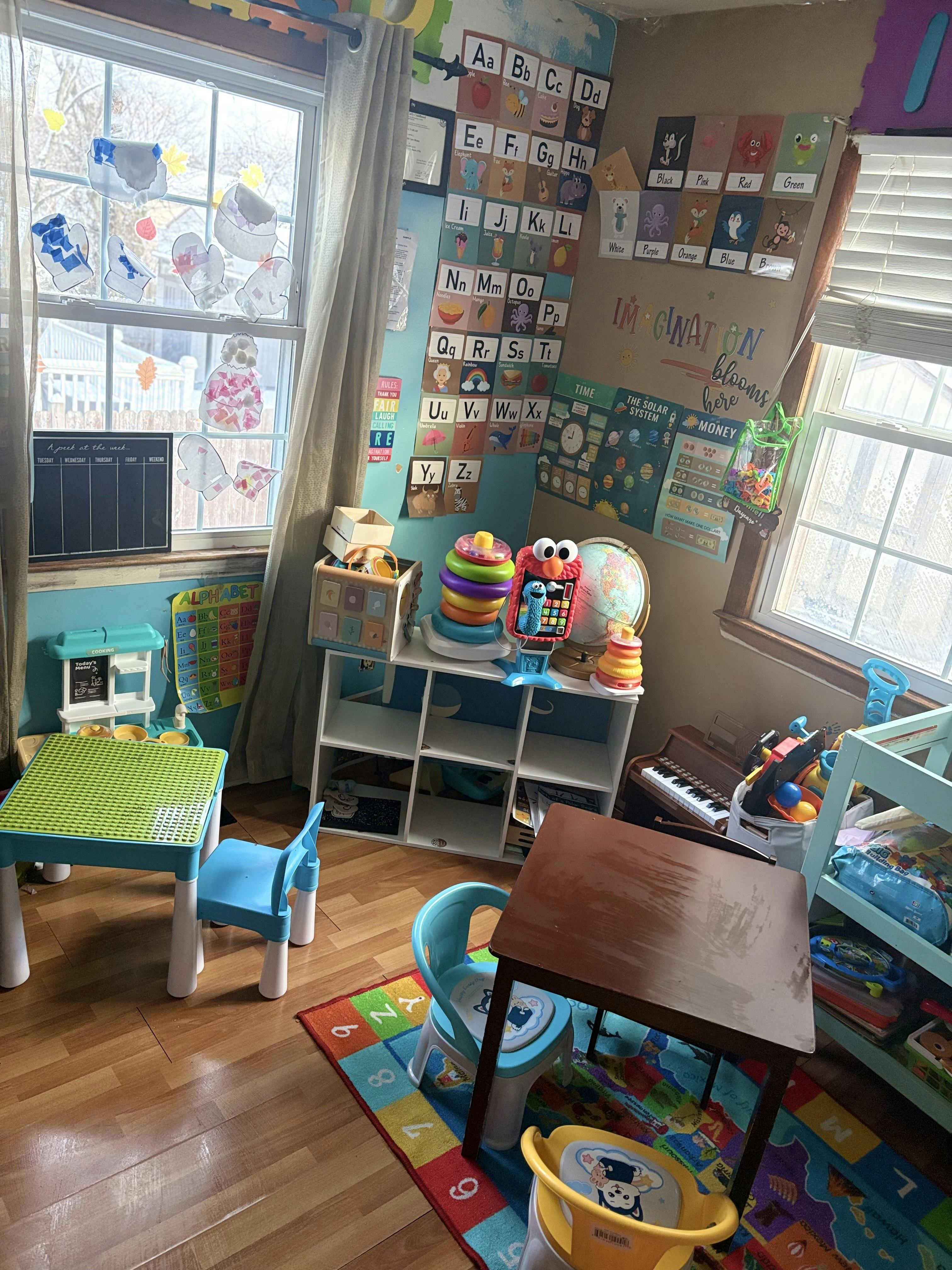 Children's classroom with alphabet, solar system, and money charts on walls