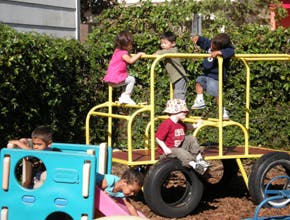 Children playing on outdoor playground equipment