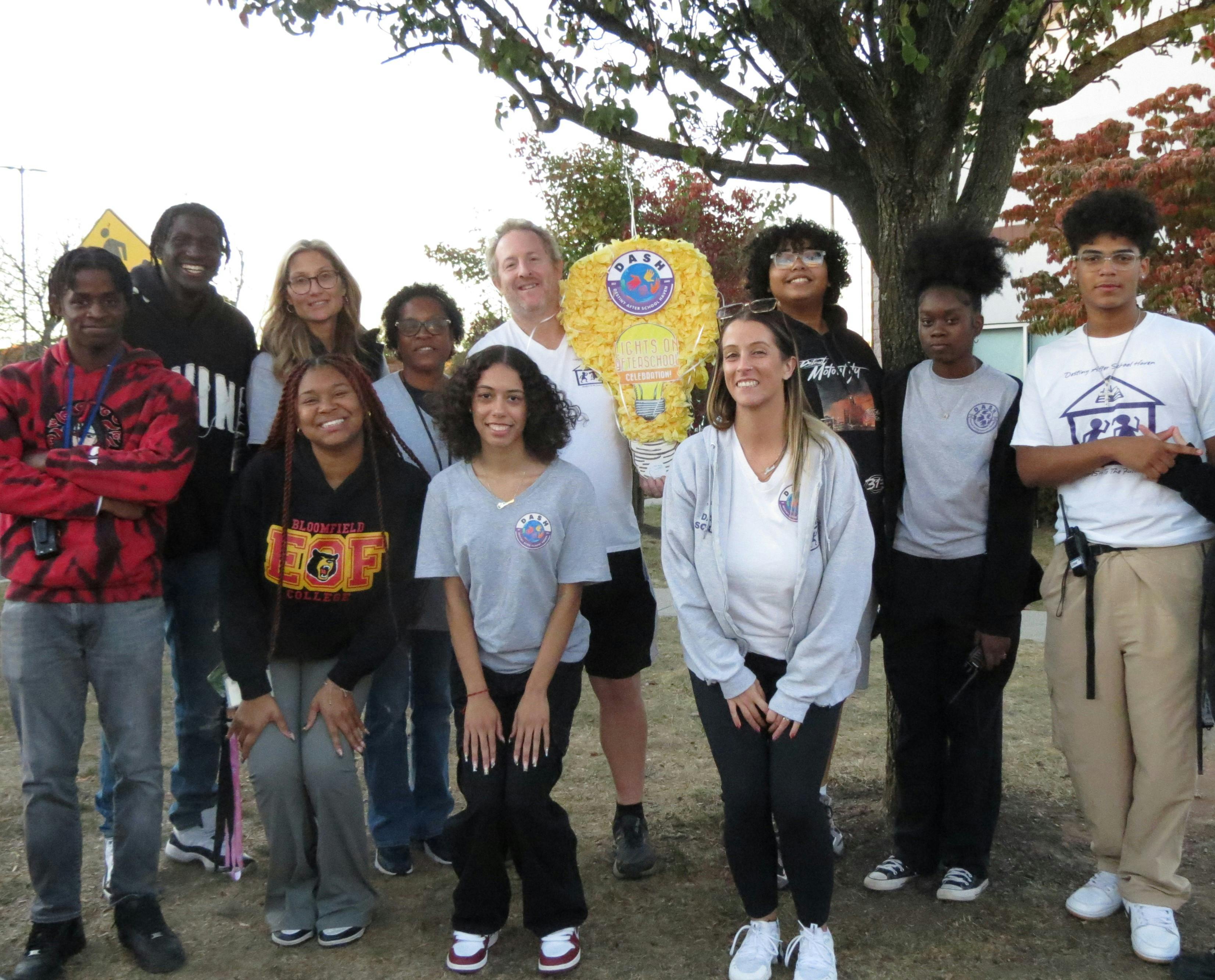 Group of people standing outdoors with a large decorative object