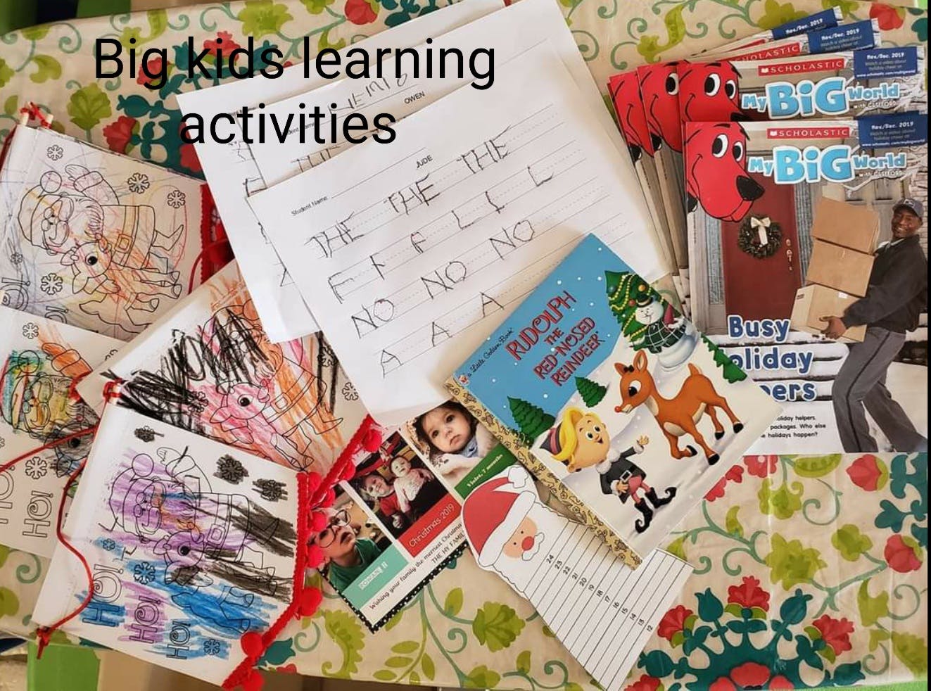 Children's drawings, handwriting practice sheets, and a book