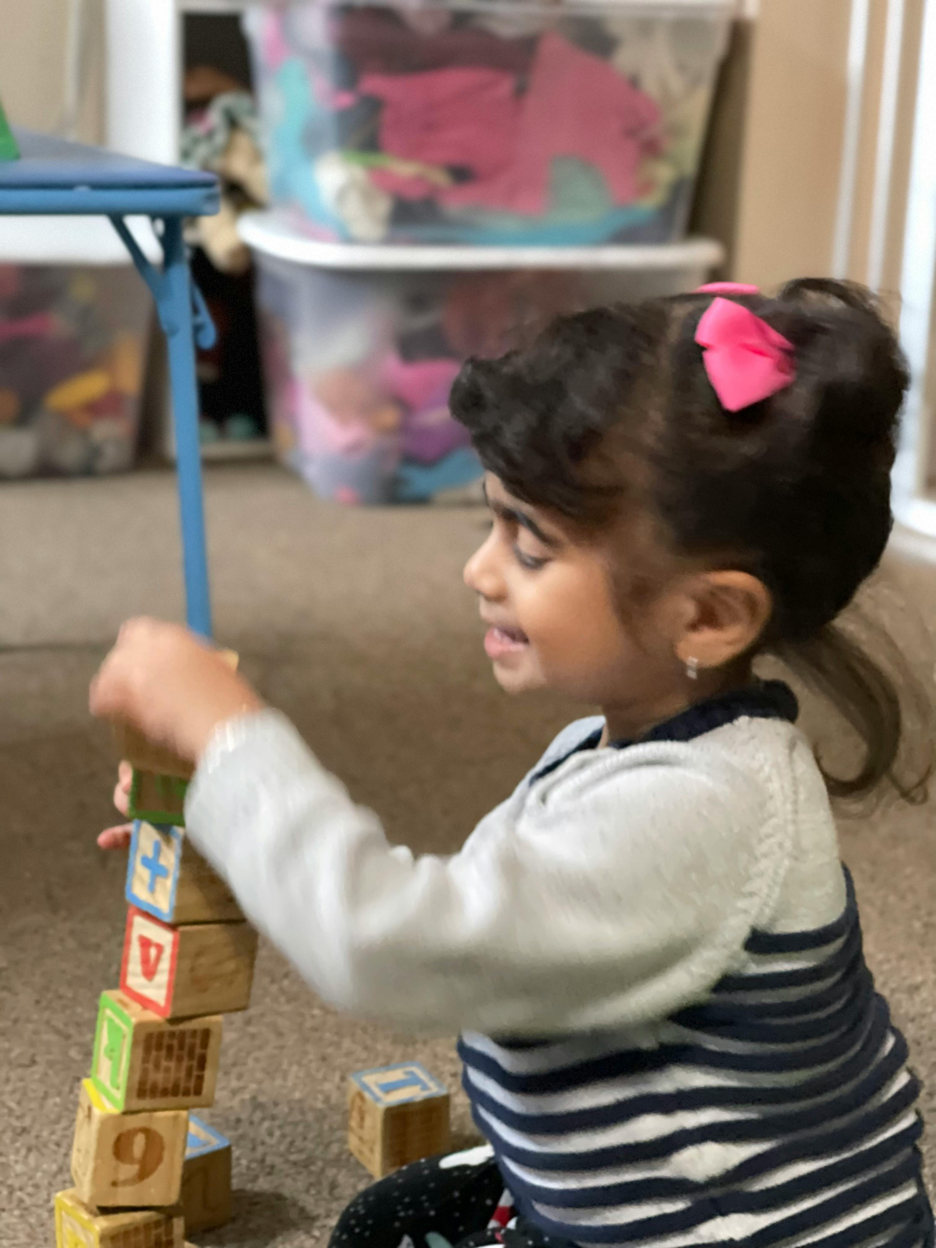 Child stacking alphabet blocks