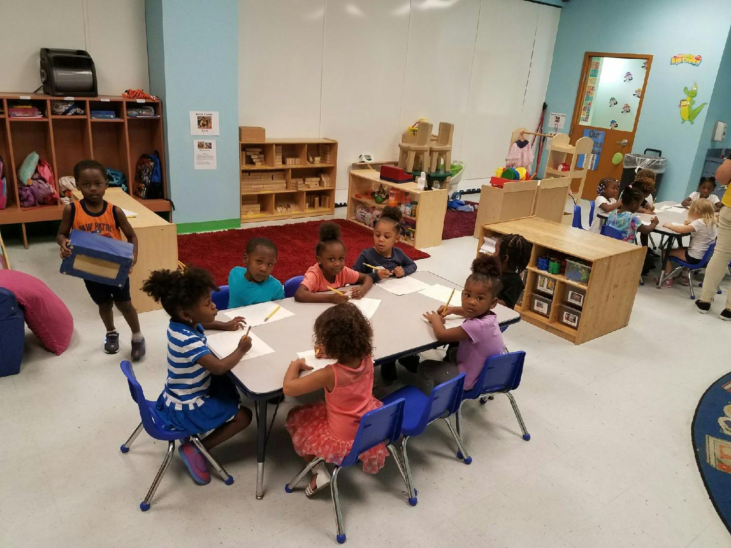 Children sitting at tables in a classroom