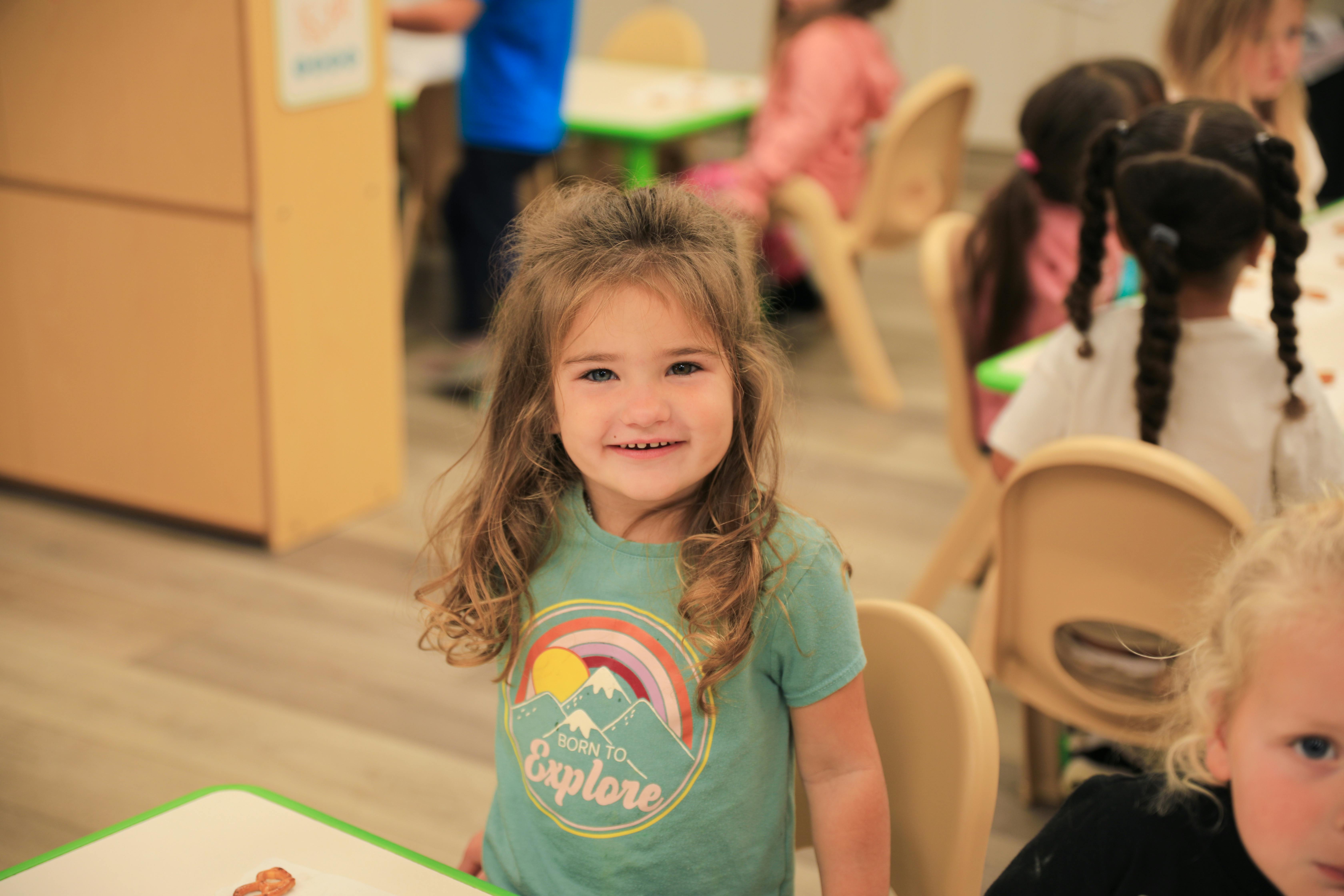 Child in a classroom smiling