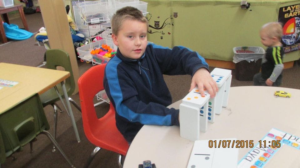 Child playing with blocks at a table