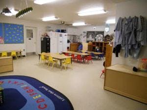 Empty classroom with small tables and chairs