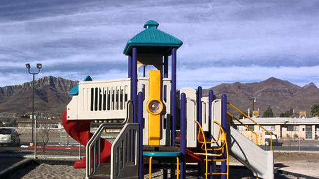 Playground structure with slides and climbing elements