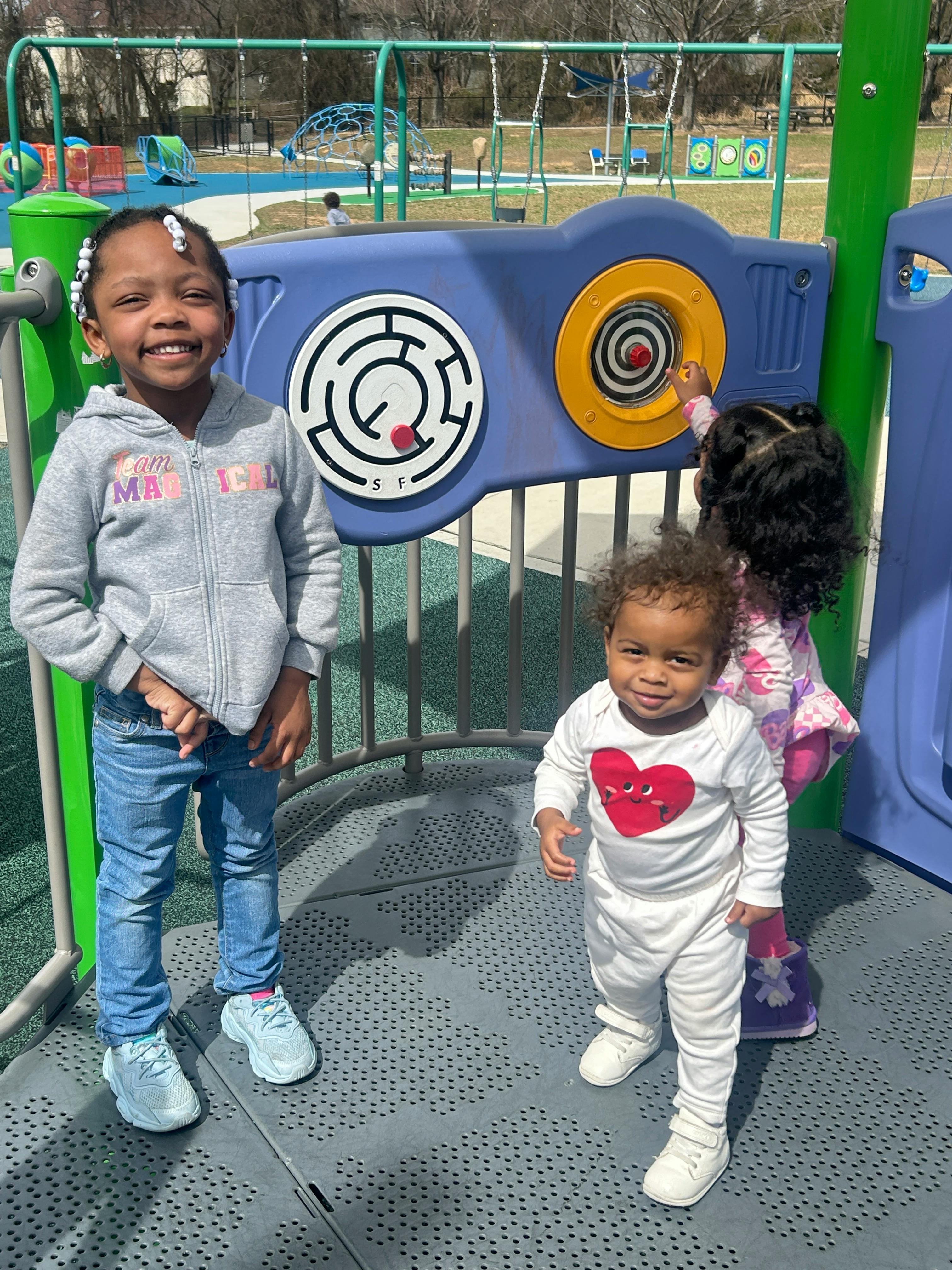 Two children and a baby on a playground