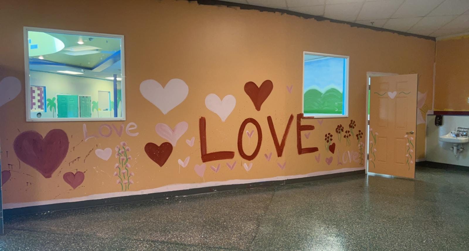 Wall with painted hearts and the word LOVE