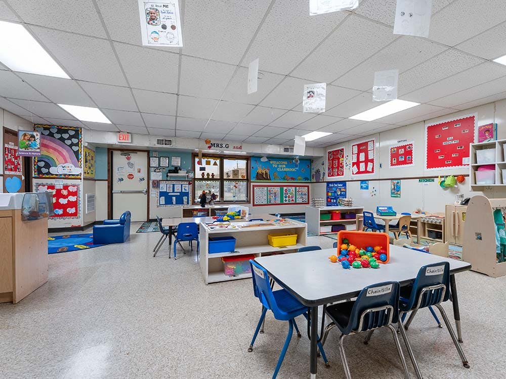 Classroom with small tables, chairs, and colorful decorations