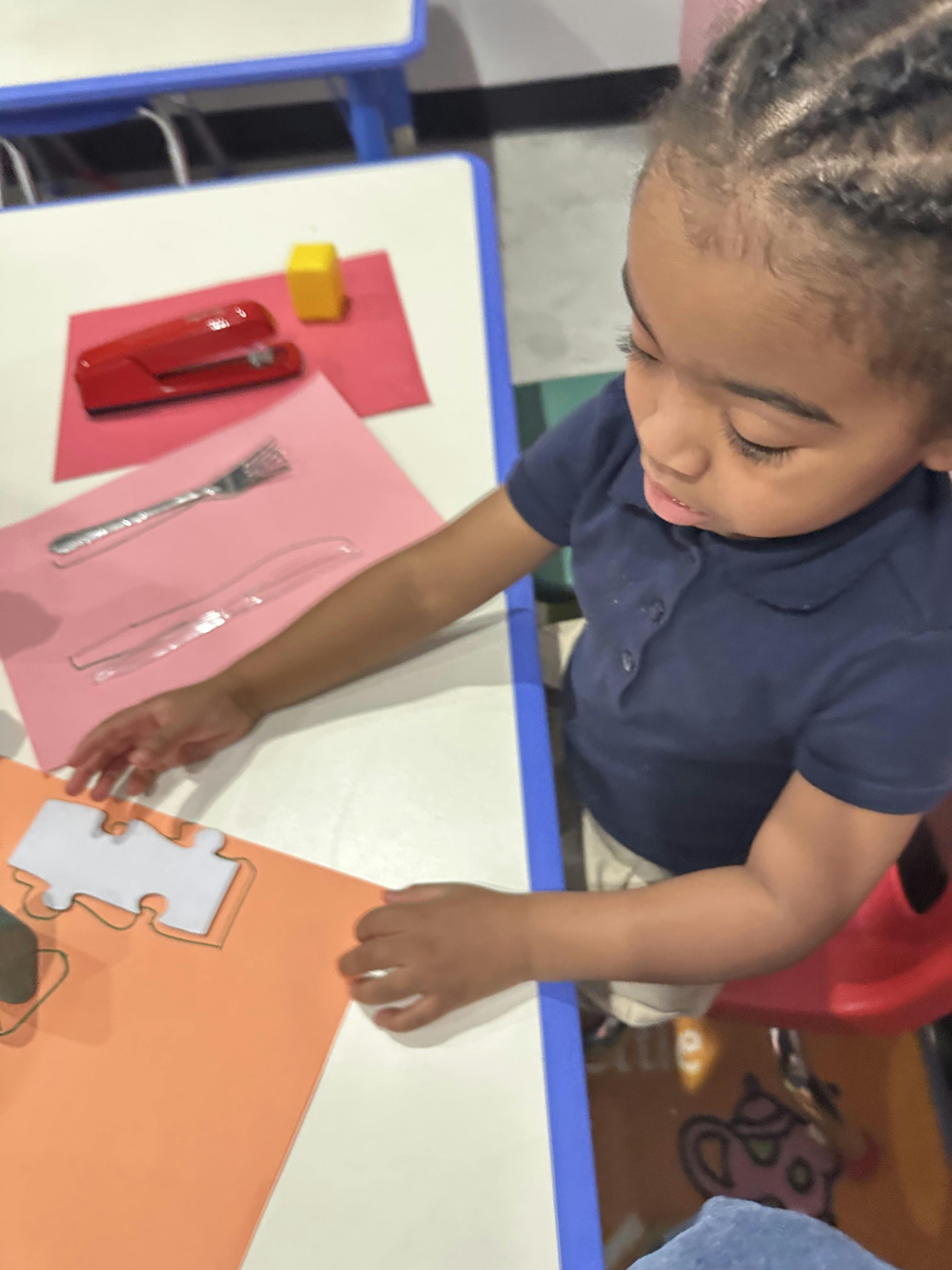 Child working on a craft project at a table