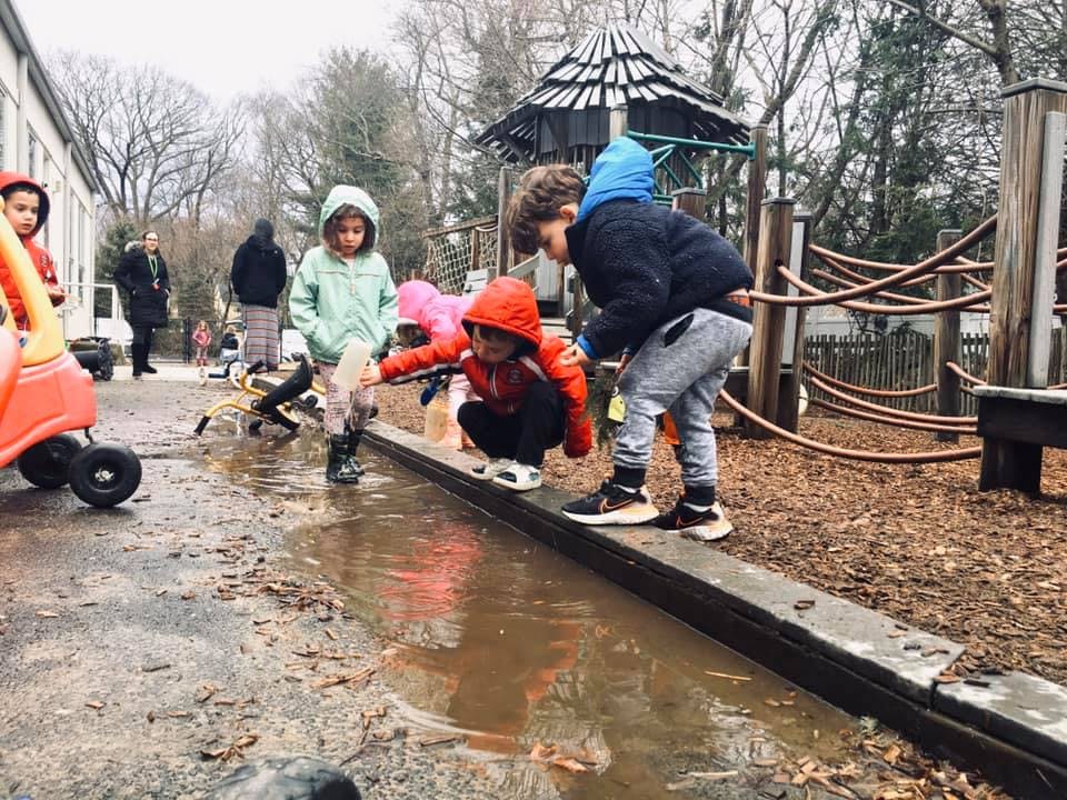 Children playing in a puddle outdoors
