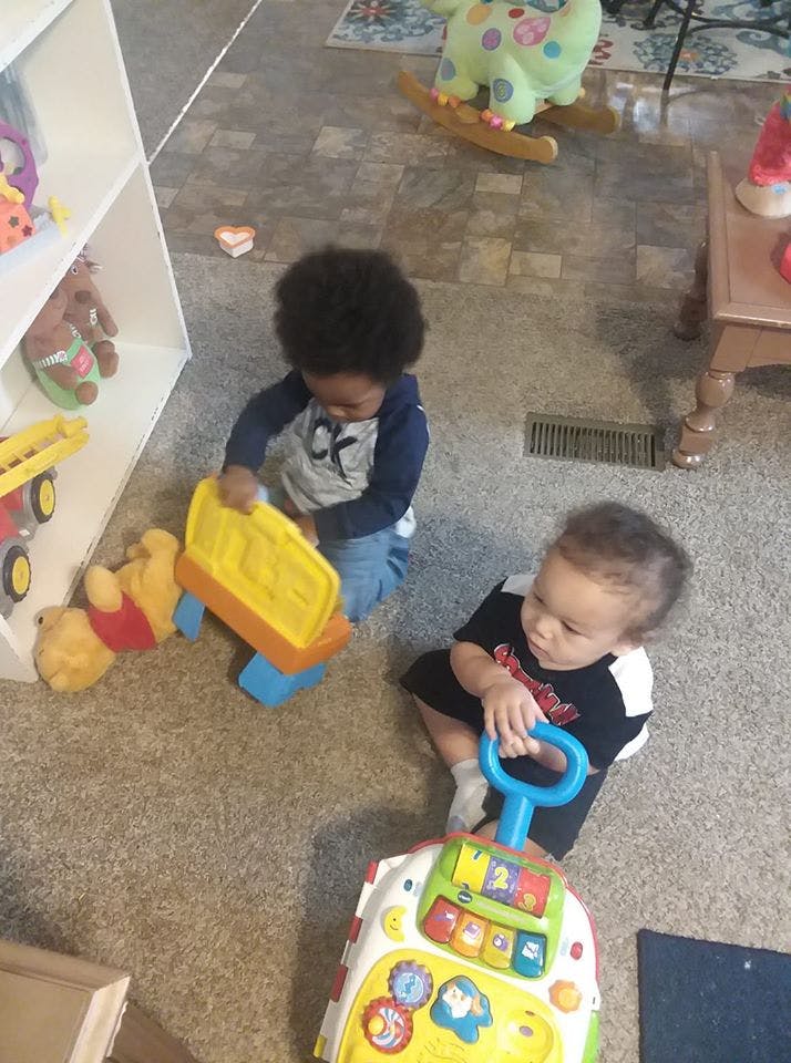 Two children playing with toys on the floor