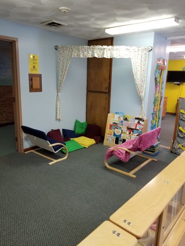 Reading nook with two small chairs and colorful cushions