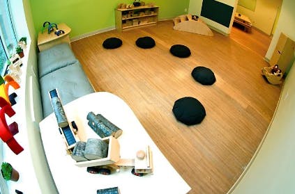 Classroom with wooden floor and black cushions