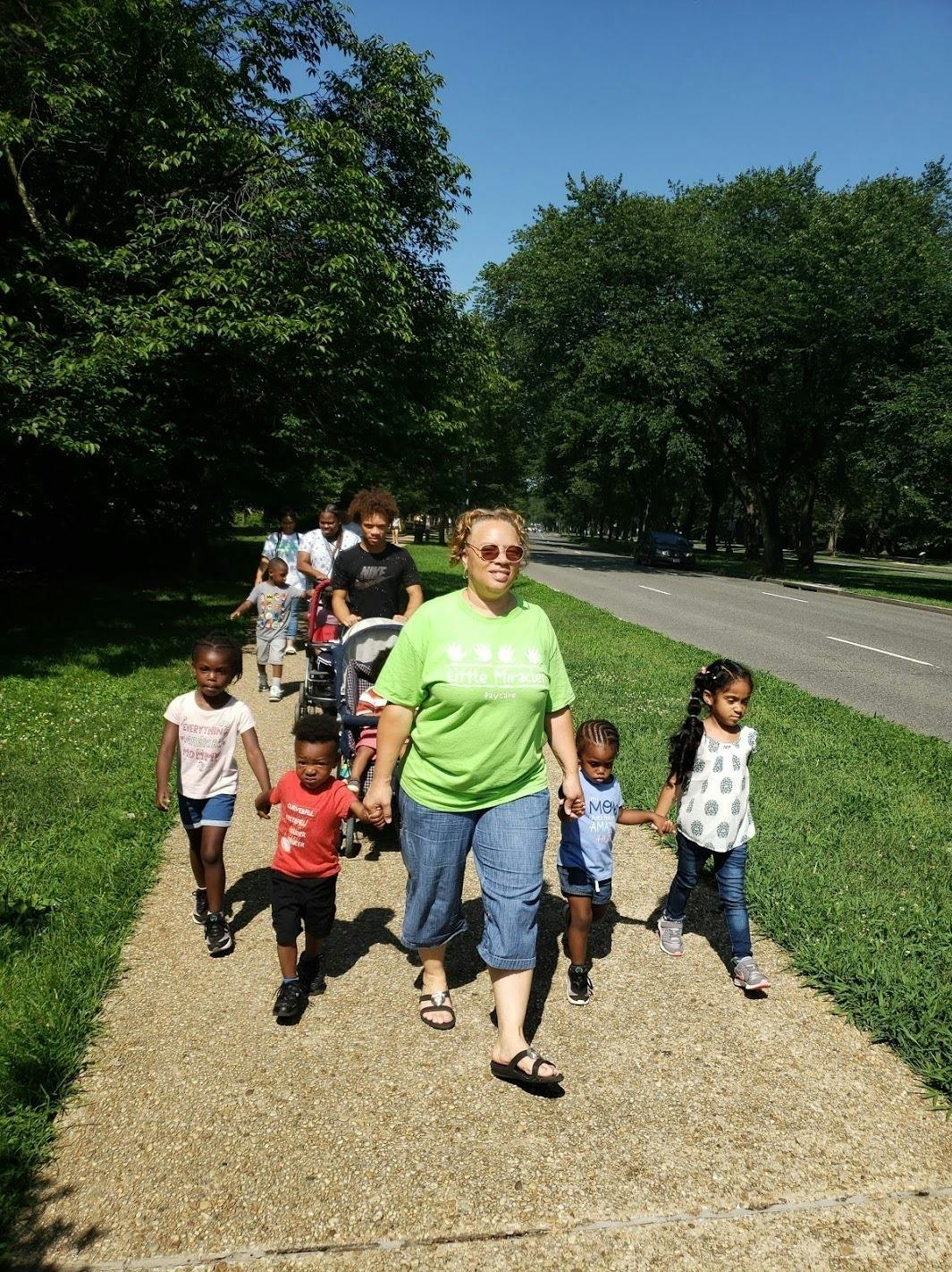 Adults and children walking on a path outdoors
