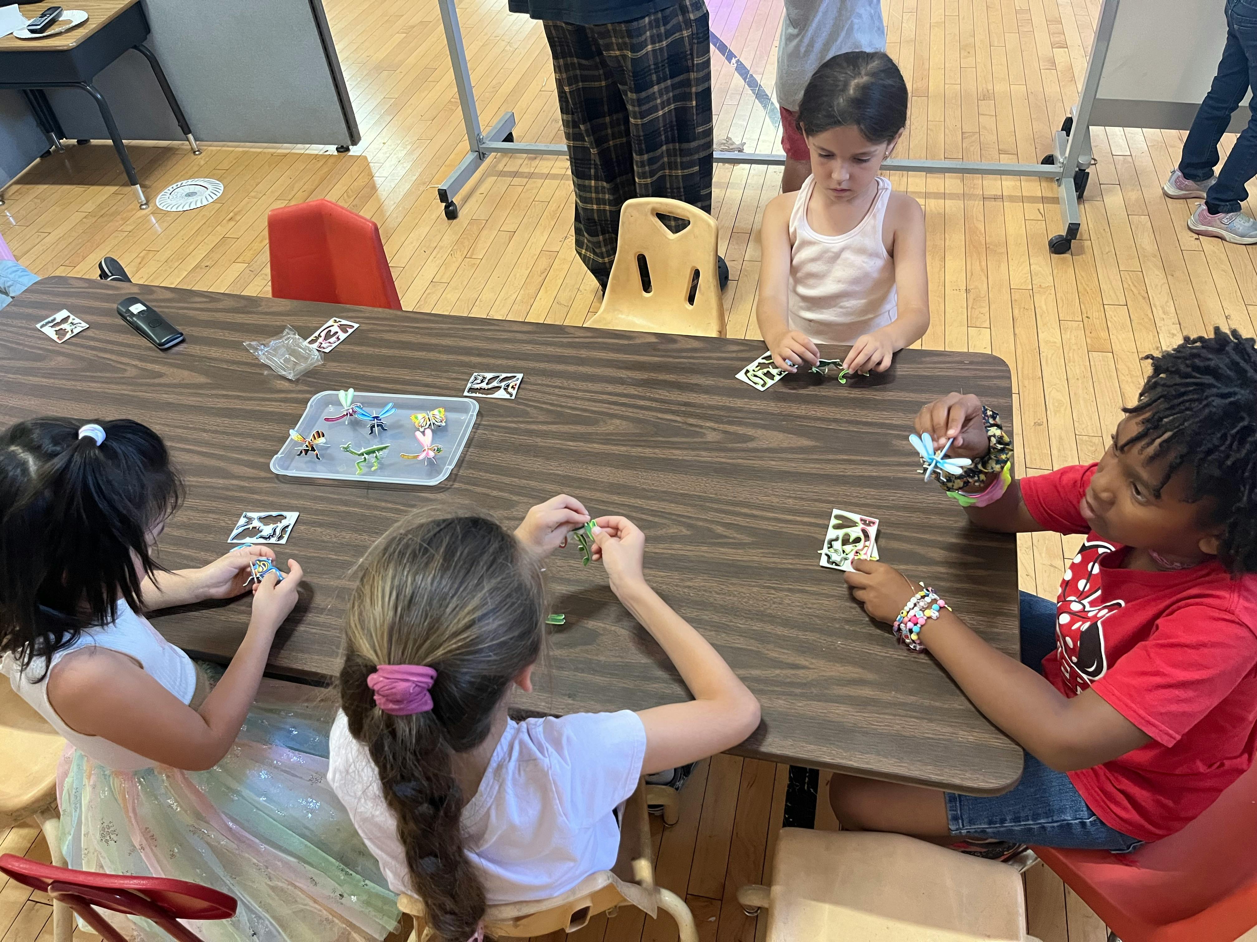 Children playing a card game at a table