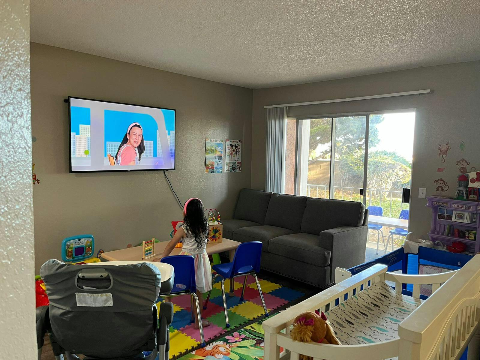 Child sitting at a table watching television