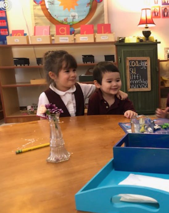 Two children sitting at a table