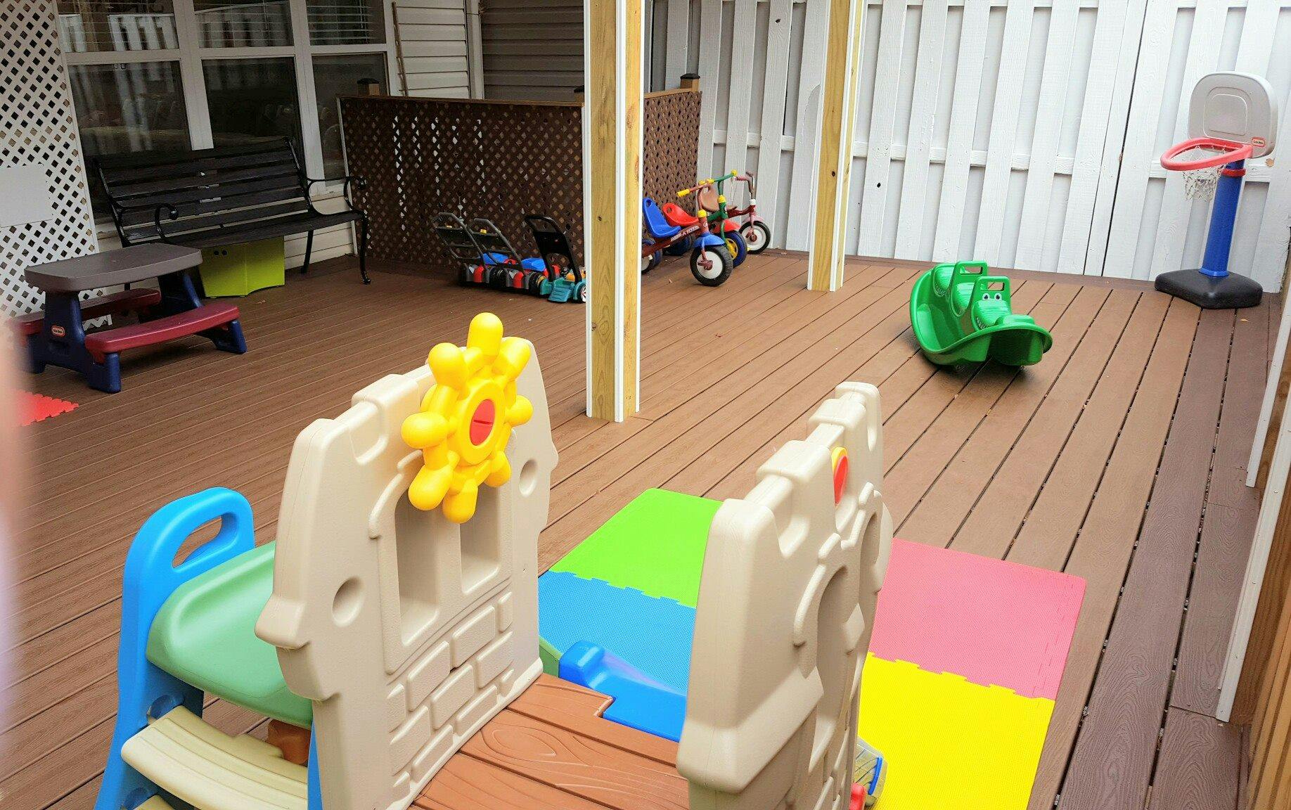 Outdoor deck with children's play equipment and sports equipment