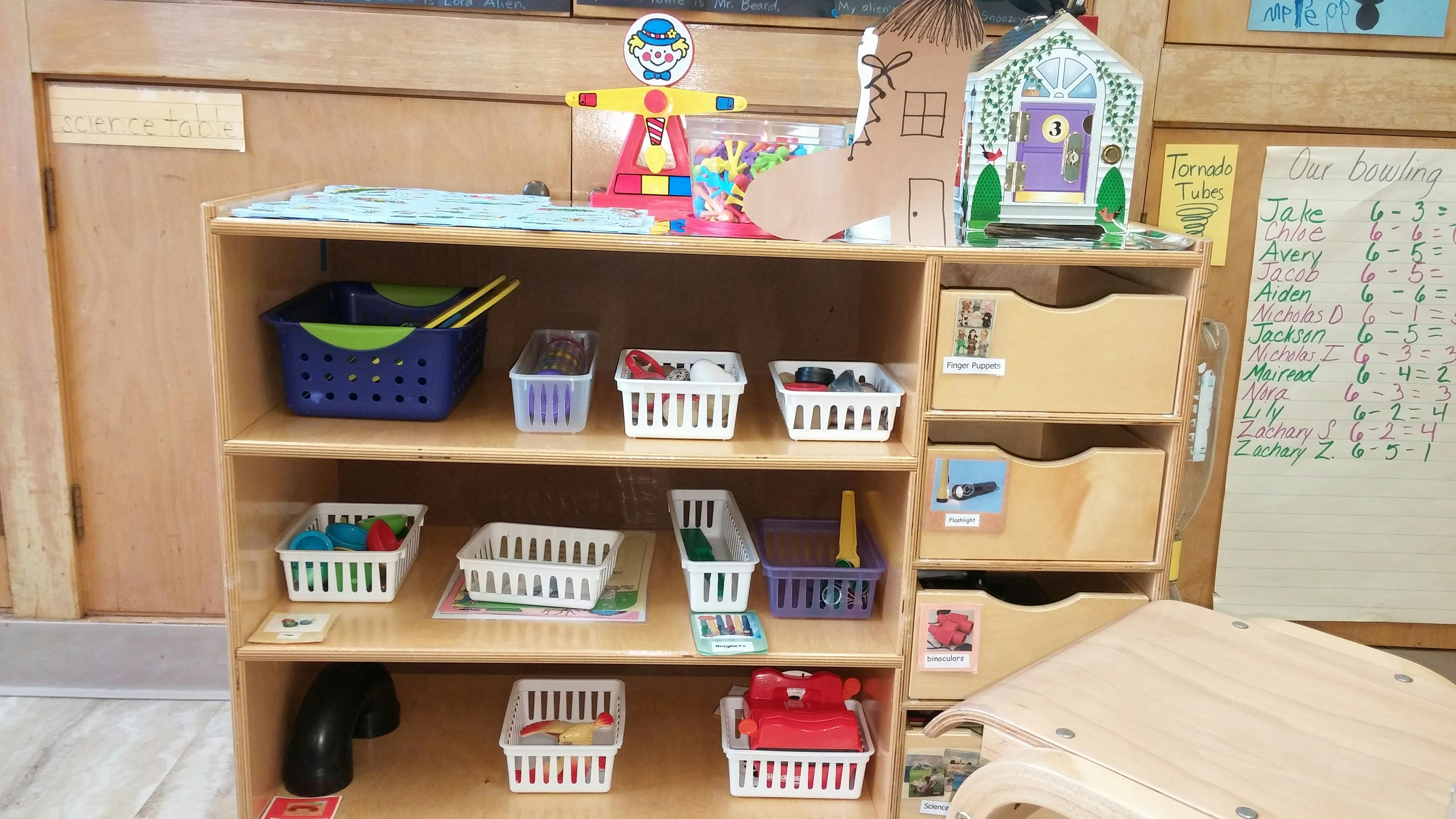 Shelving unit with baskets and toys in a classroom