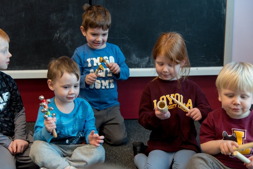Children playing with musical instruments in a classroom