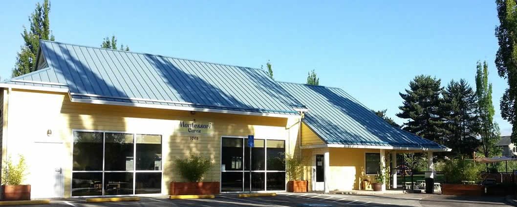 Yellow building with a blue roof and large windows