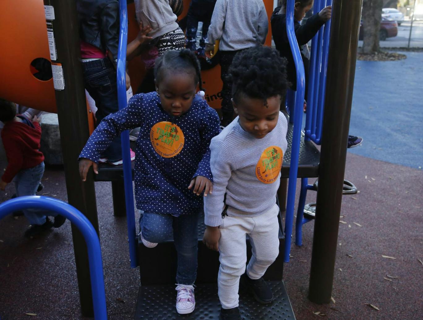 Two children on playground equipment