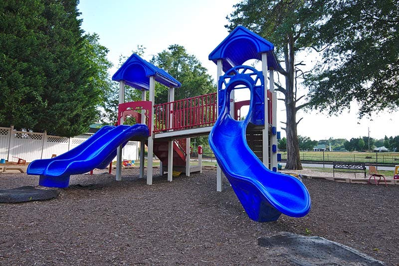 Playground with blue slides and red railings