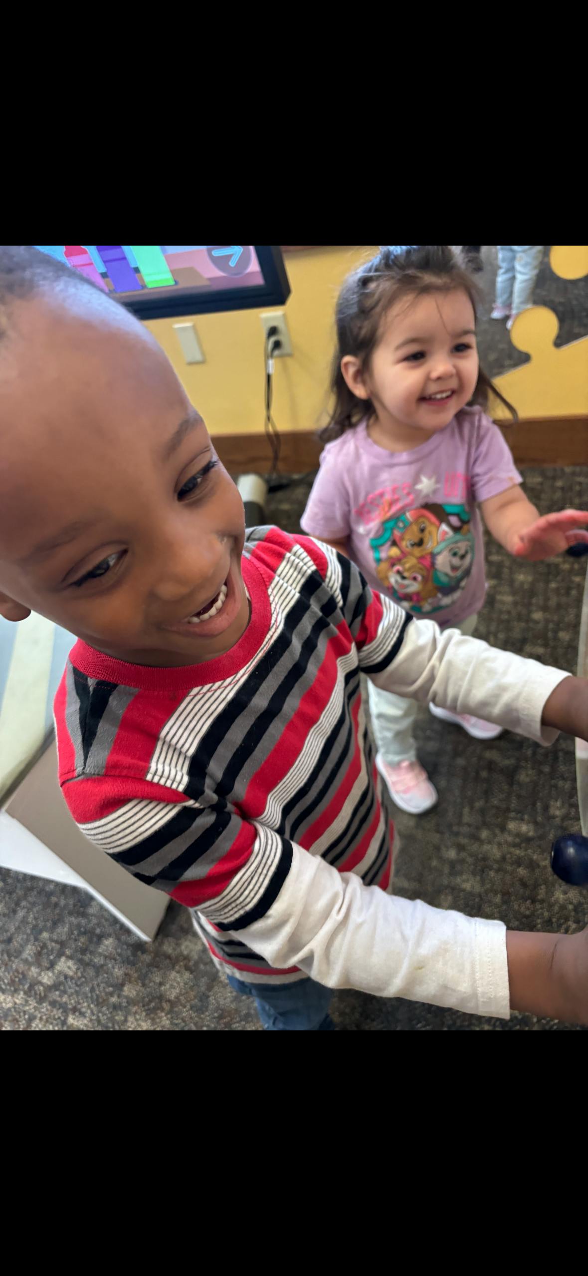 Two children playing together at an indoor activity center