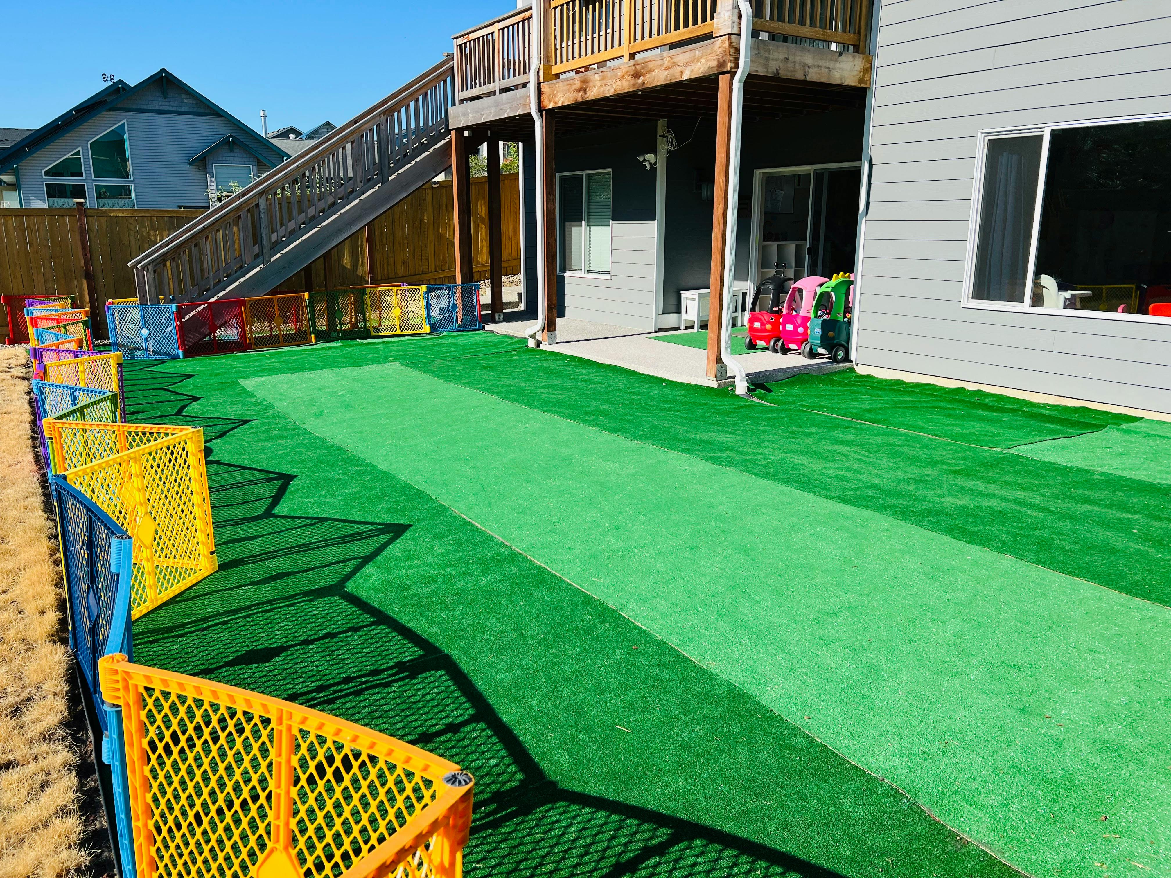 Backyard with artificial turf and a multi-level deck