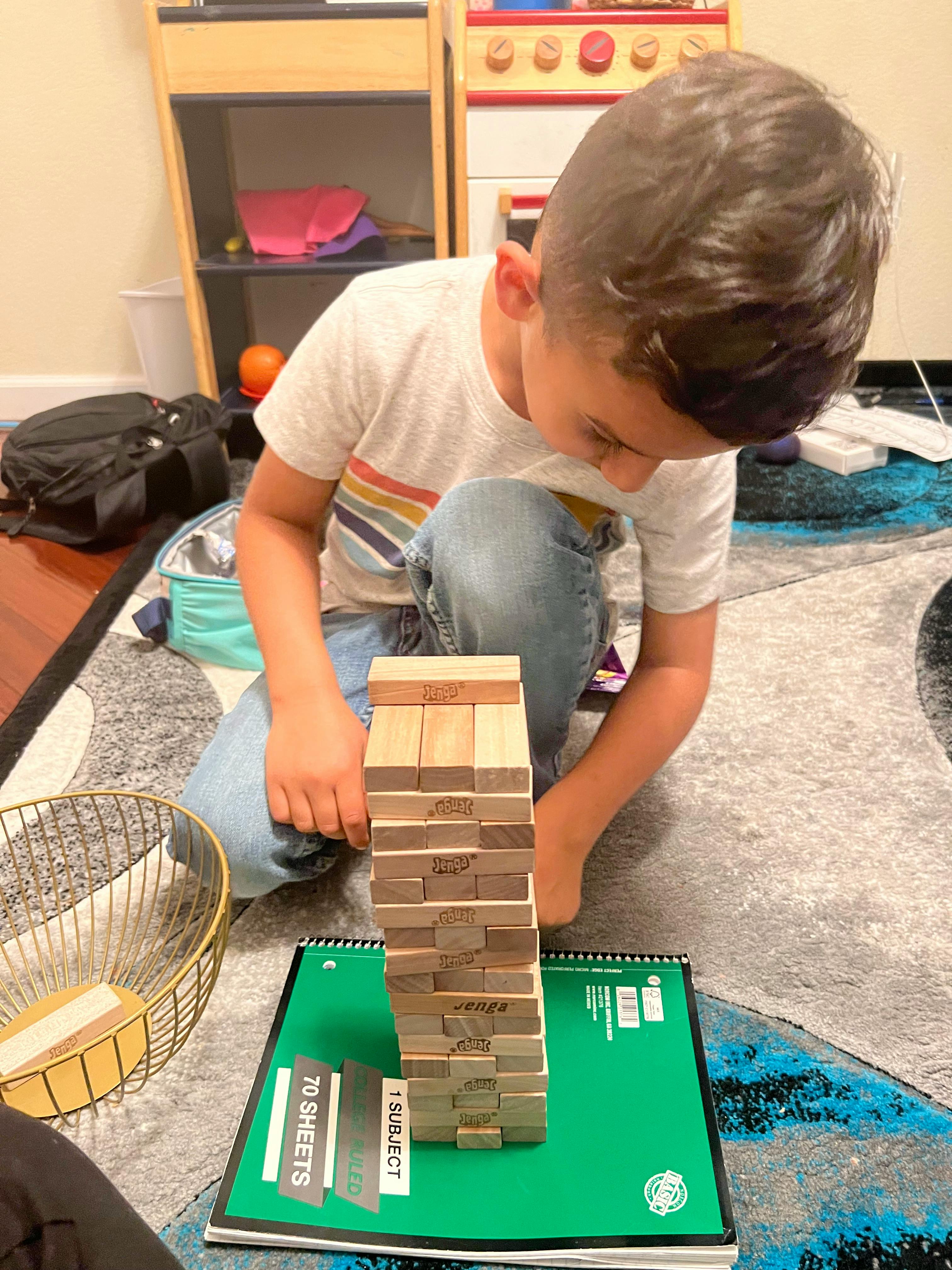 Child playing with a Jenga tower