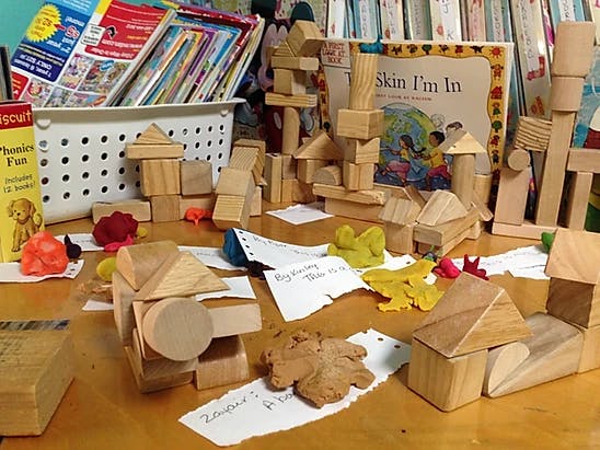 Wooden blocks arranged on a table with a book titled "Skin I'm In"