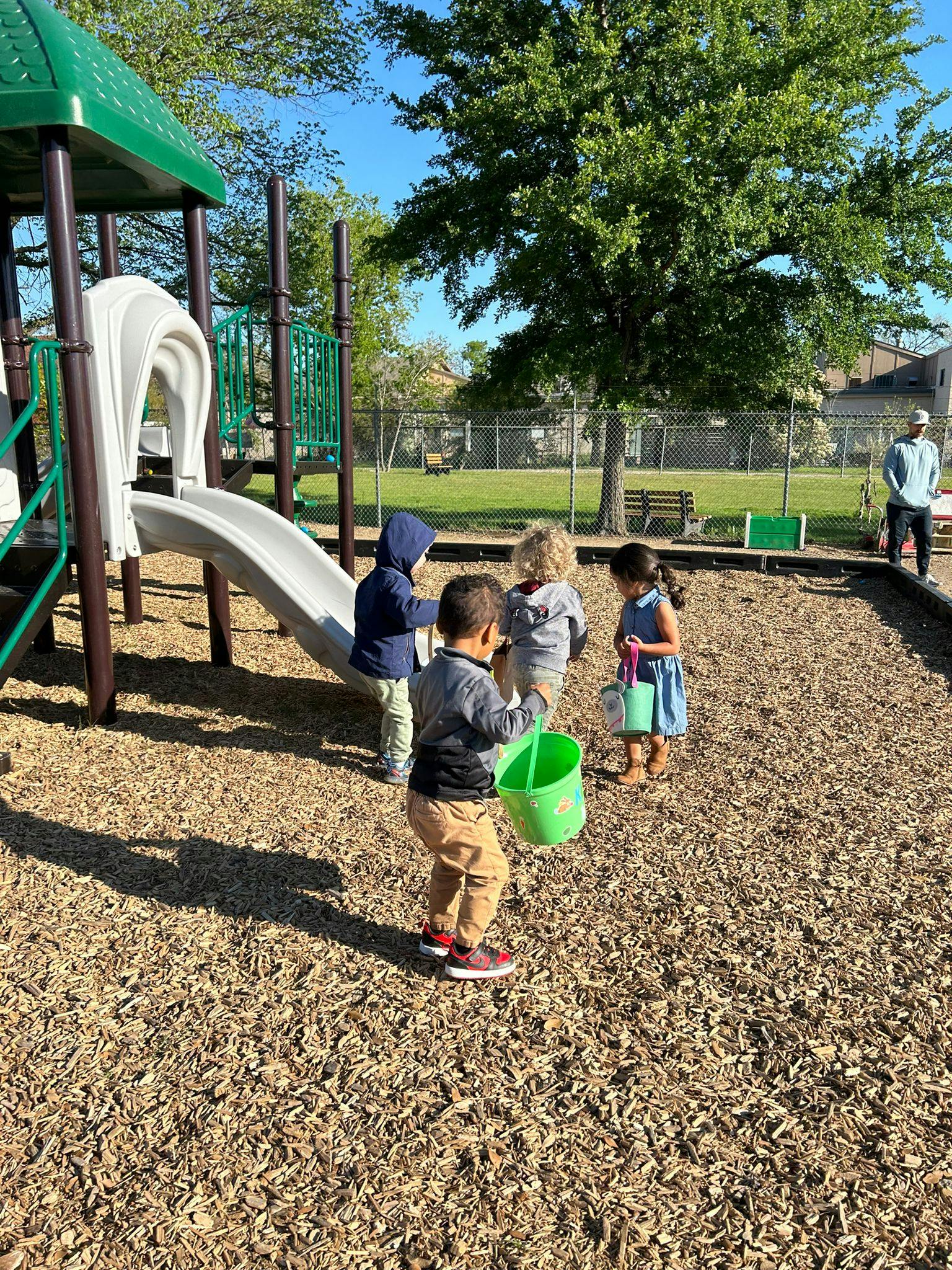 Children playing with buckets on a playground