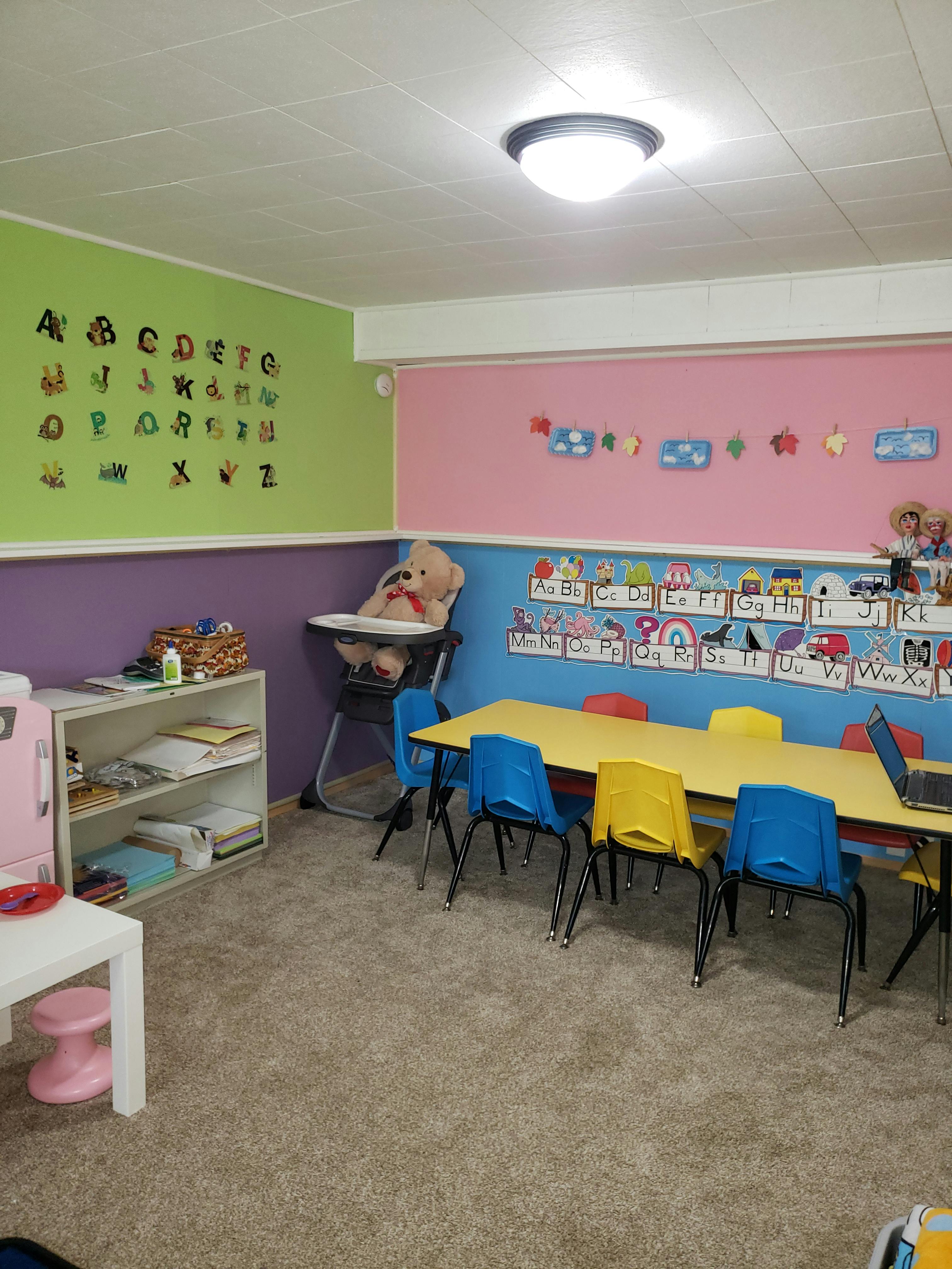 Child's playroom with small table and chairs, alphabet on wall
