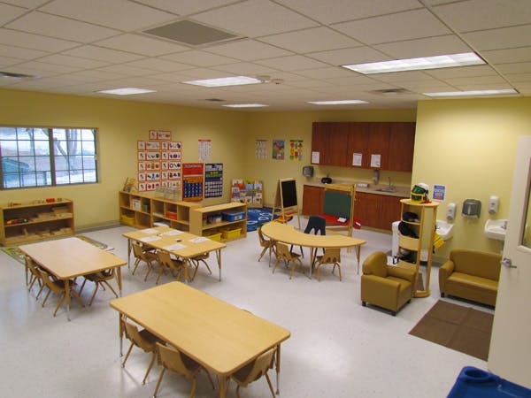 Empty classroom with small tables and chairs