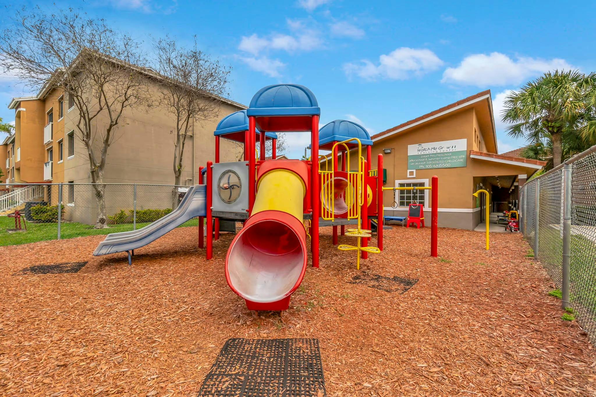 Playground with slides and climbing structures on wood chips