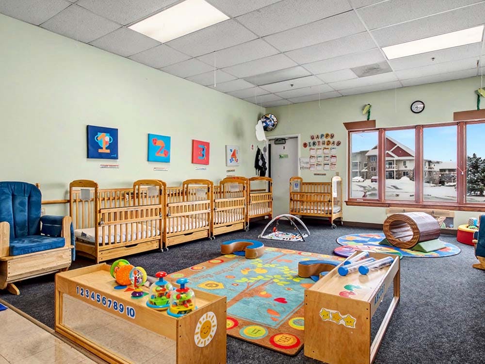 Cribs and toys in a daycare classroom