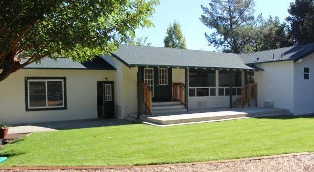 House with a porch and green lawn