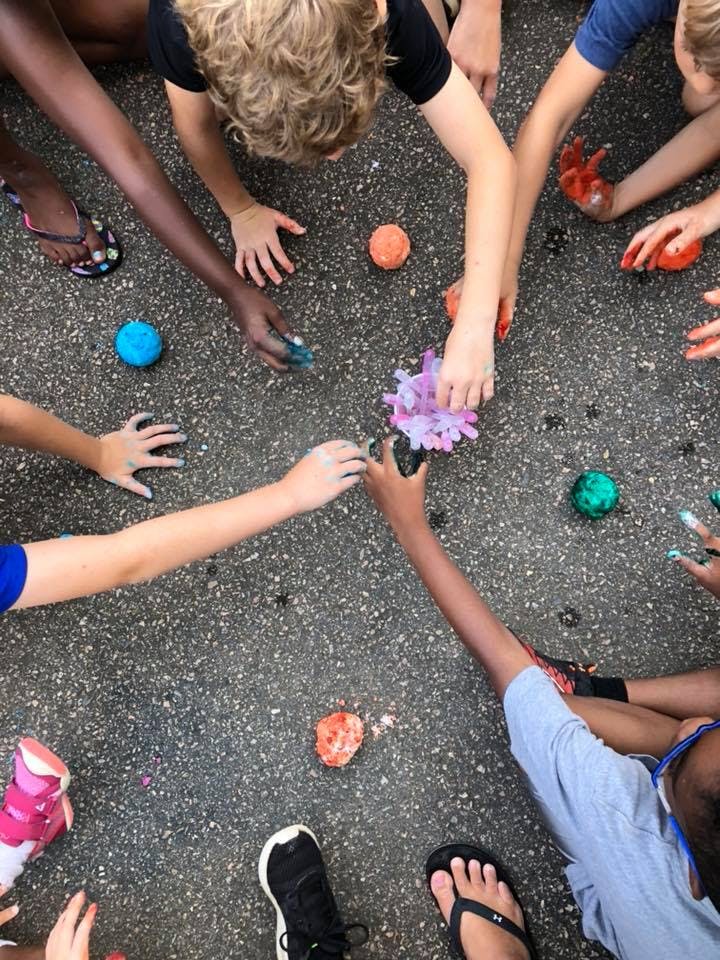 Children playing with colorful slime on the ground