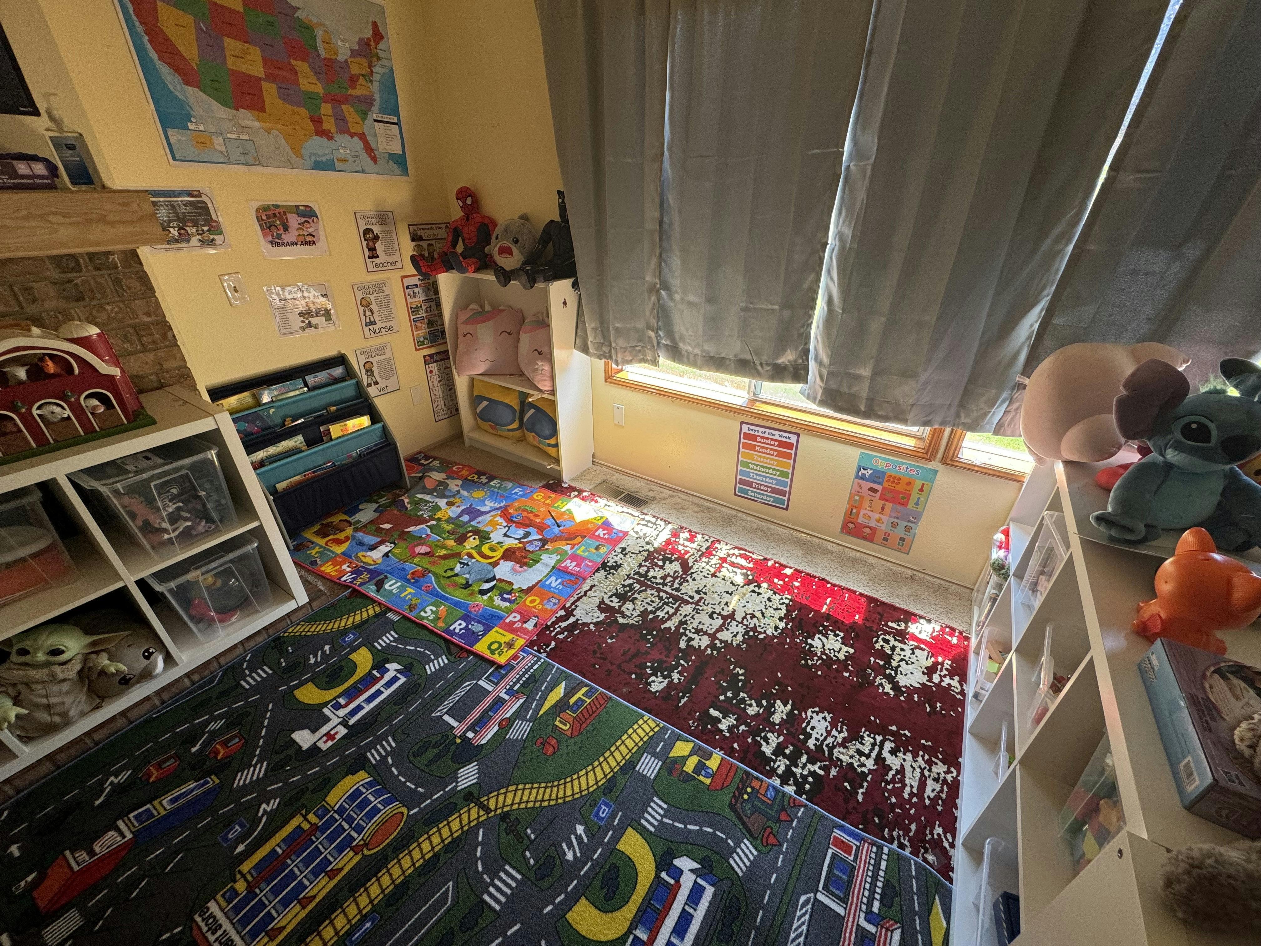 Playroom with colorful rugs, shelves, and toys