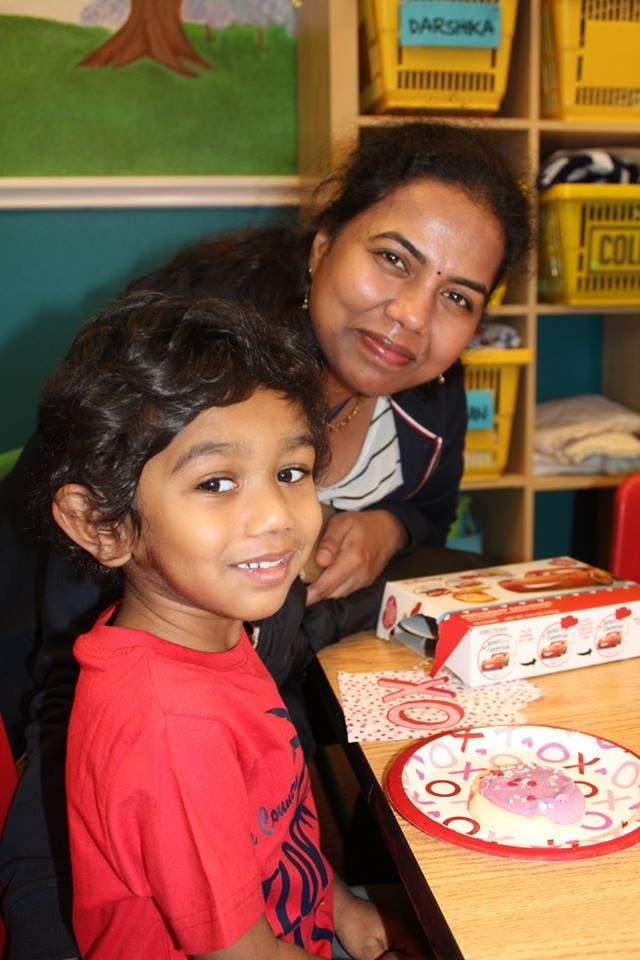 Adult and child smiling at the camera
